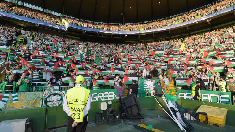 Celtic fans displaying Palestine flags at Celtic Park.