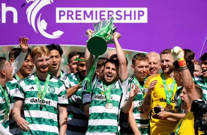 Greg Taylor lifts the cup