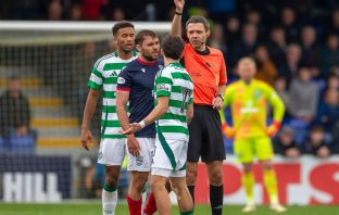 Nicolas Kuhn receives a yellow card from referee Kevin Clancy