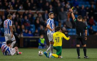 Nick Walsh shows Reo Hatate a yellow card.