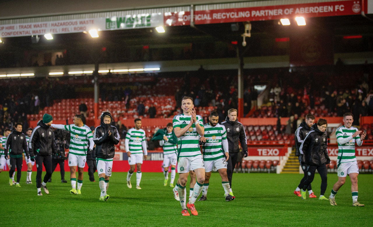Alistair Johnston leads the Celtic players to applaud the fans