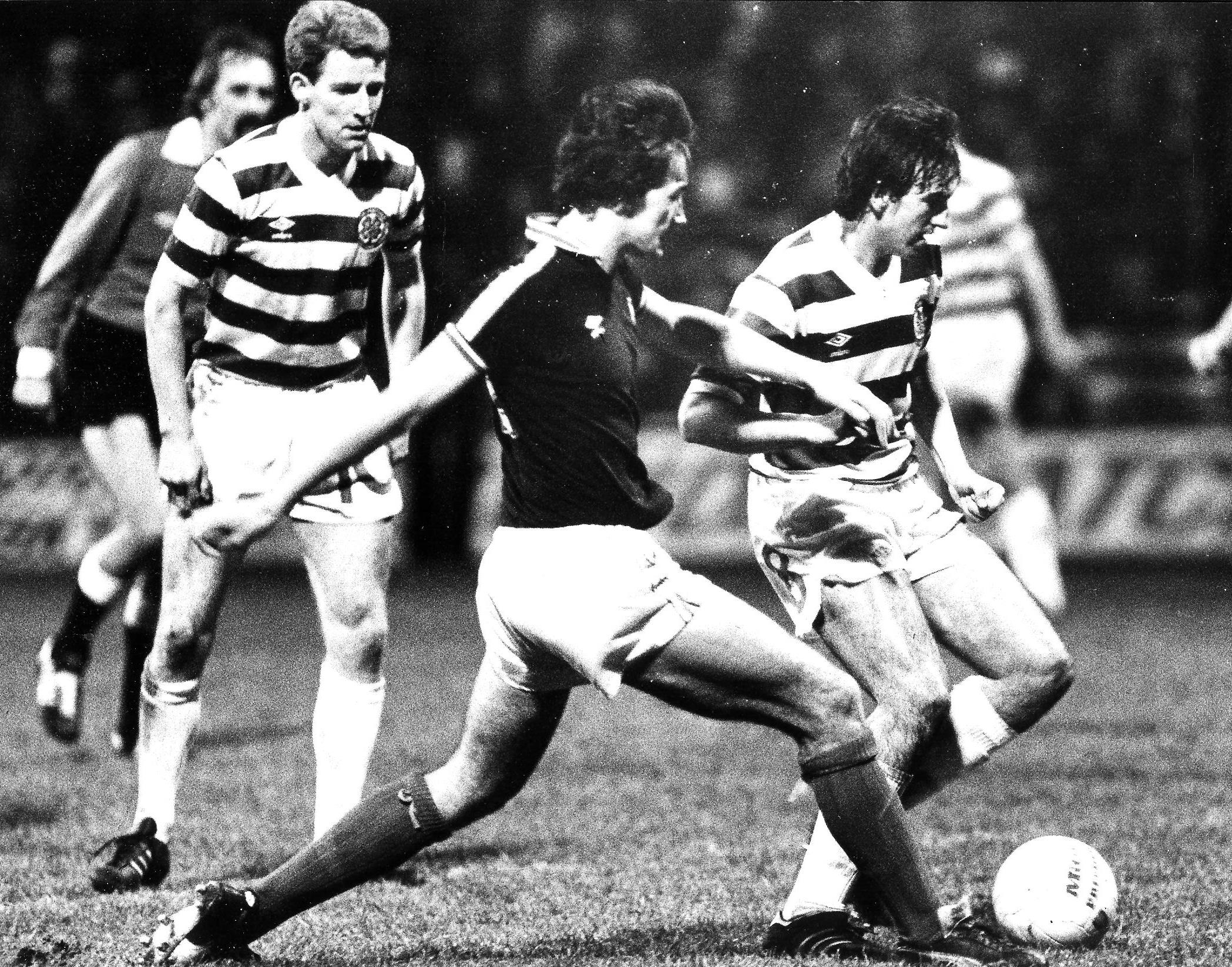Mike Conroy on the ball as Tommy Burns watches on