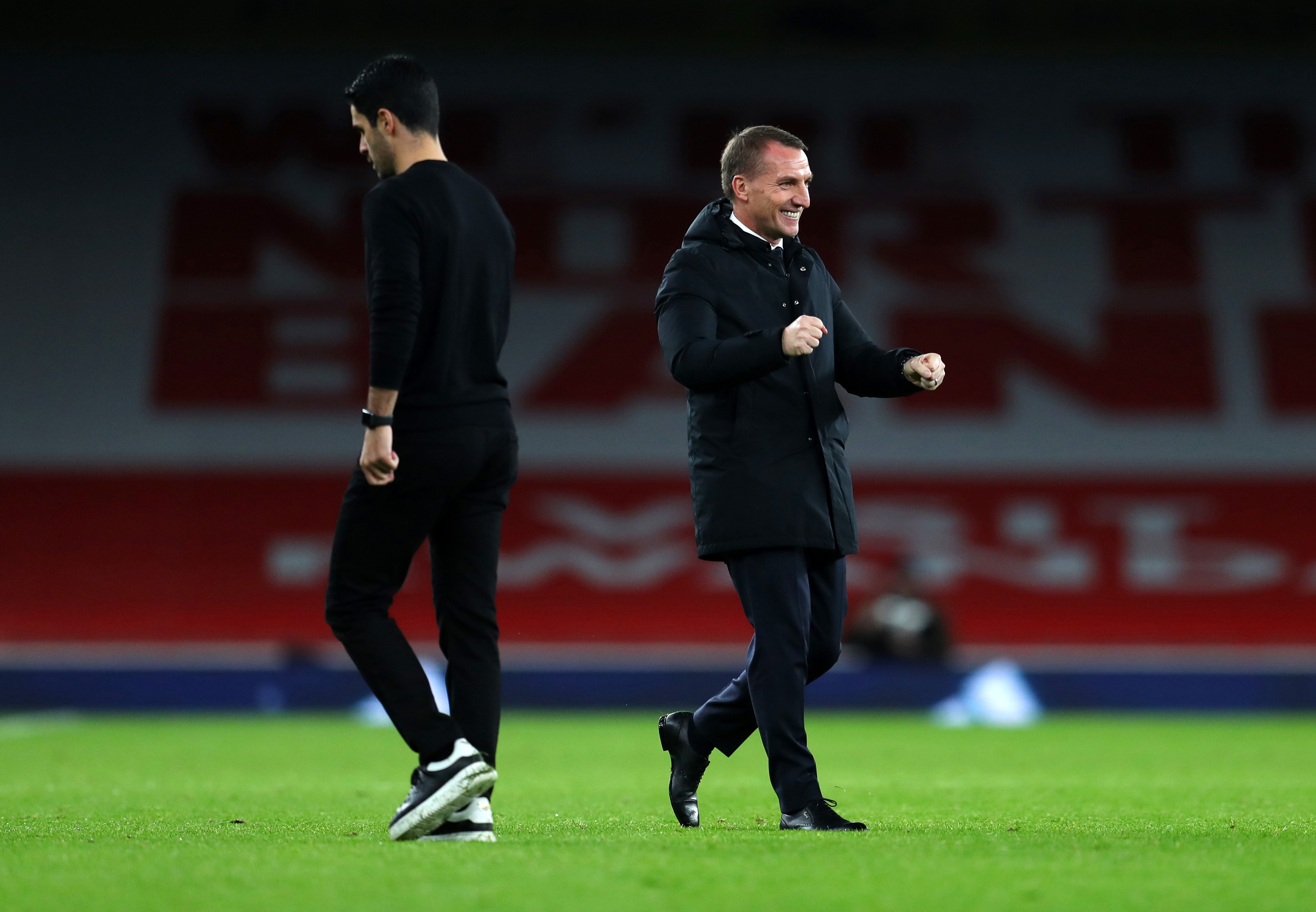 Brendon Rodgers celebrates as he walks past Mikel Arteta