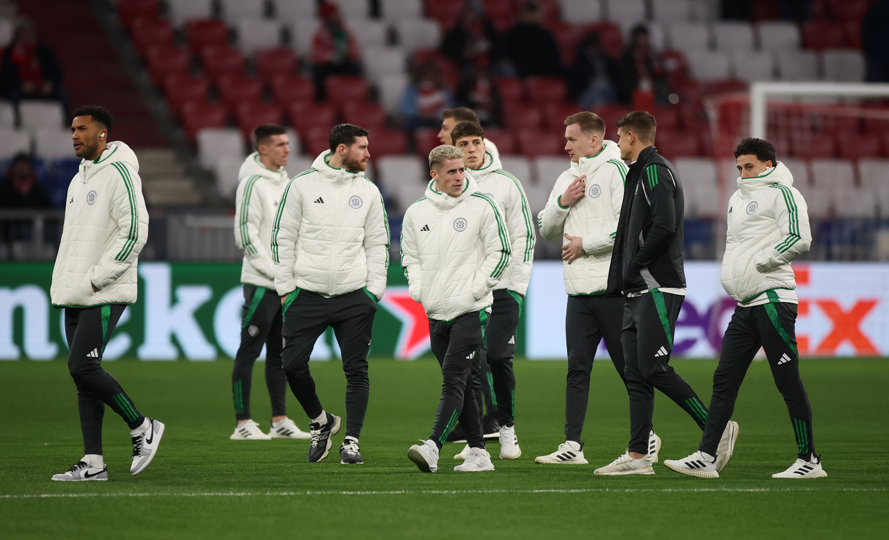 Celtic players inspect the pitch