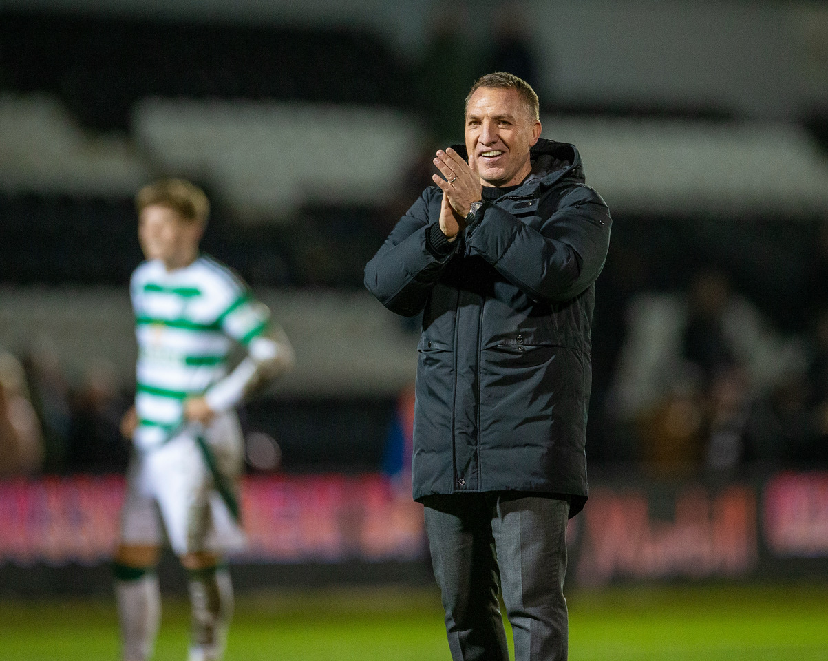 Brendan Rodgers applauds the away support.