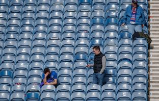 A dejected theRangers fan sits with his head in his hands