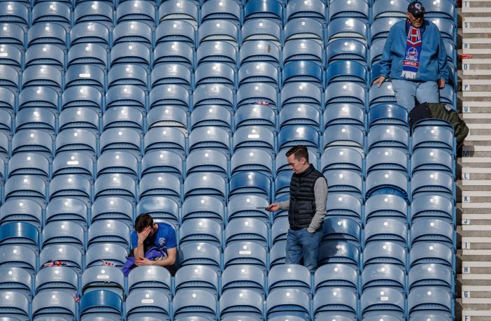 A dejected theRangers fan sits with his head in his hands