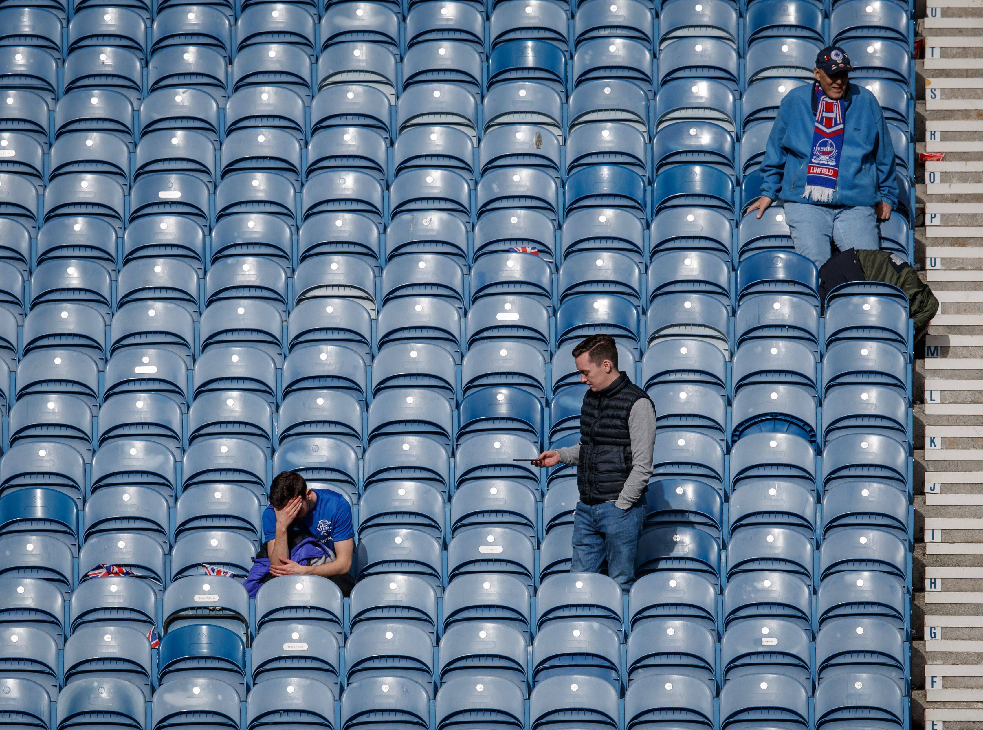 A dejected theRangers fan sits with his head in his hands