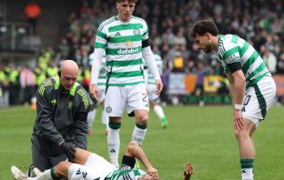 Arne Engels and Nicolas Kuhn look on as Jota receives treatment