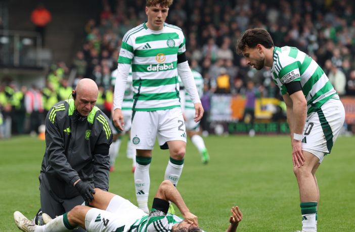 Arne Engels and Nicolas Kuhn look on as Jota receives treatment
