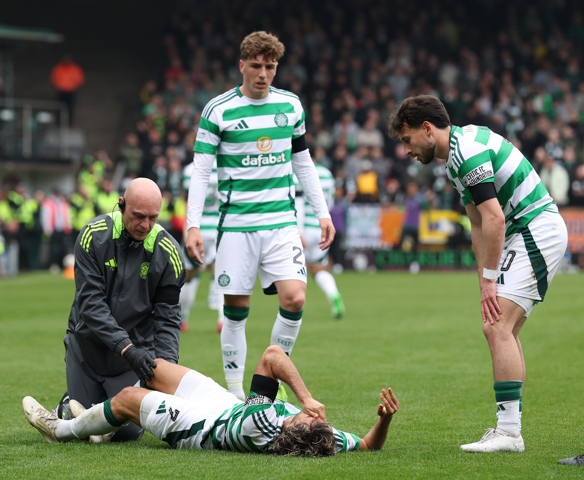 Arne Engels and Nicolas Kuhn look on as Jota receives treatment
