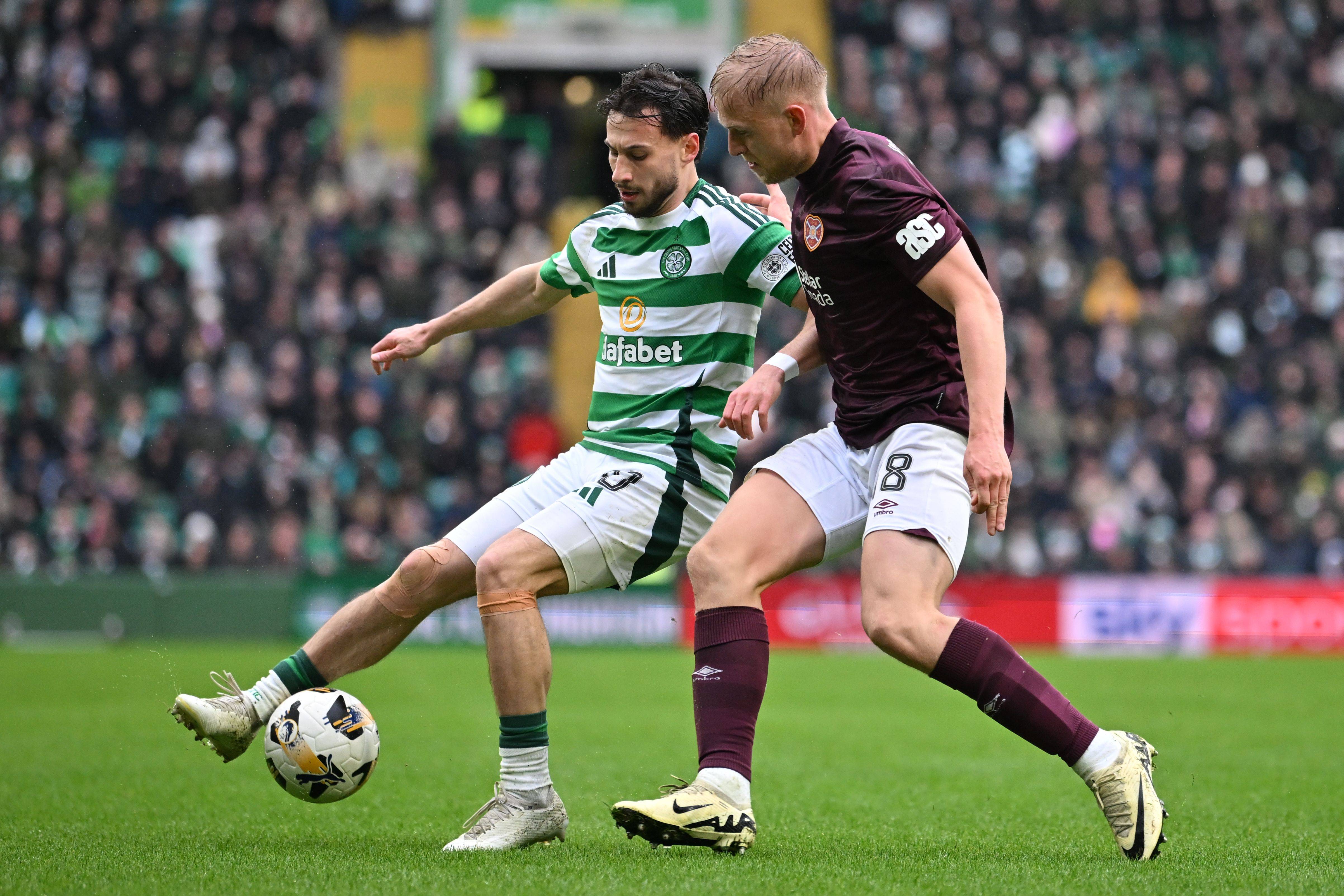 Nicolas Kuhn of Celtic vies with Harry Milne of Hearts