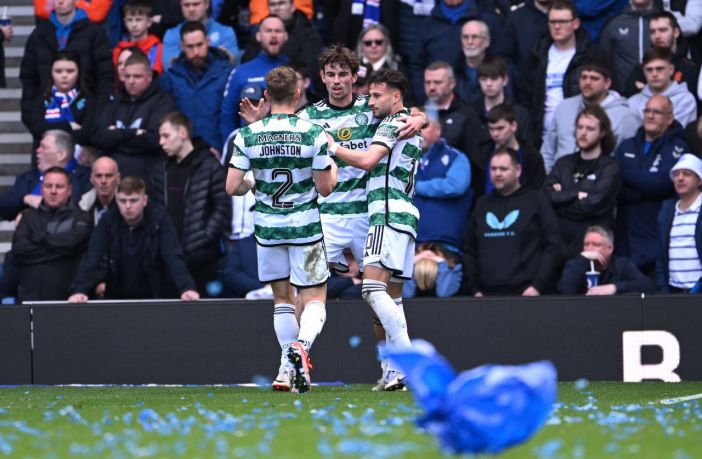 Matt O'Riley celebrates with Celtic teammates at Ibrox