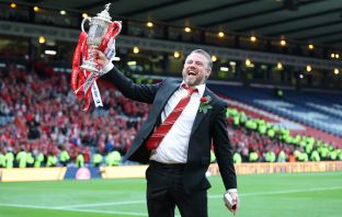 Aberdeen manager Jimmy Thelin lifts the trophy
