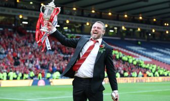 Aberdeen manager Jimmy Thelin lifts the trophy