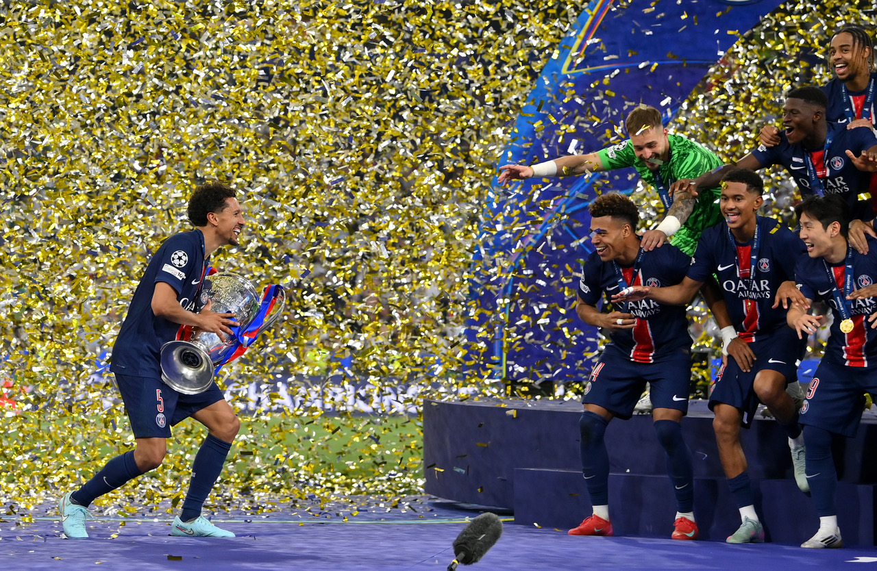 Marquinhos of Paris Saint-Germain prepares to lift the UEFA Champions League trophy