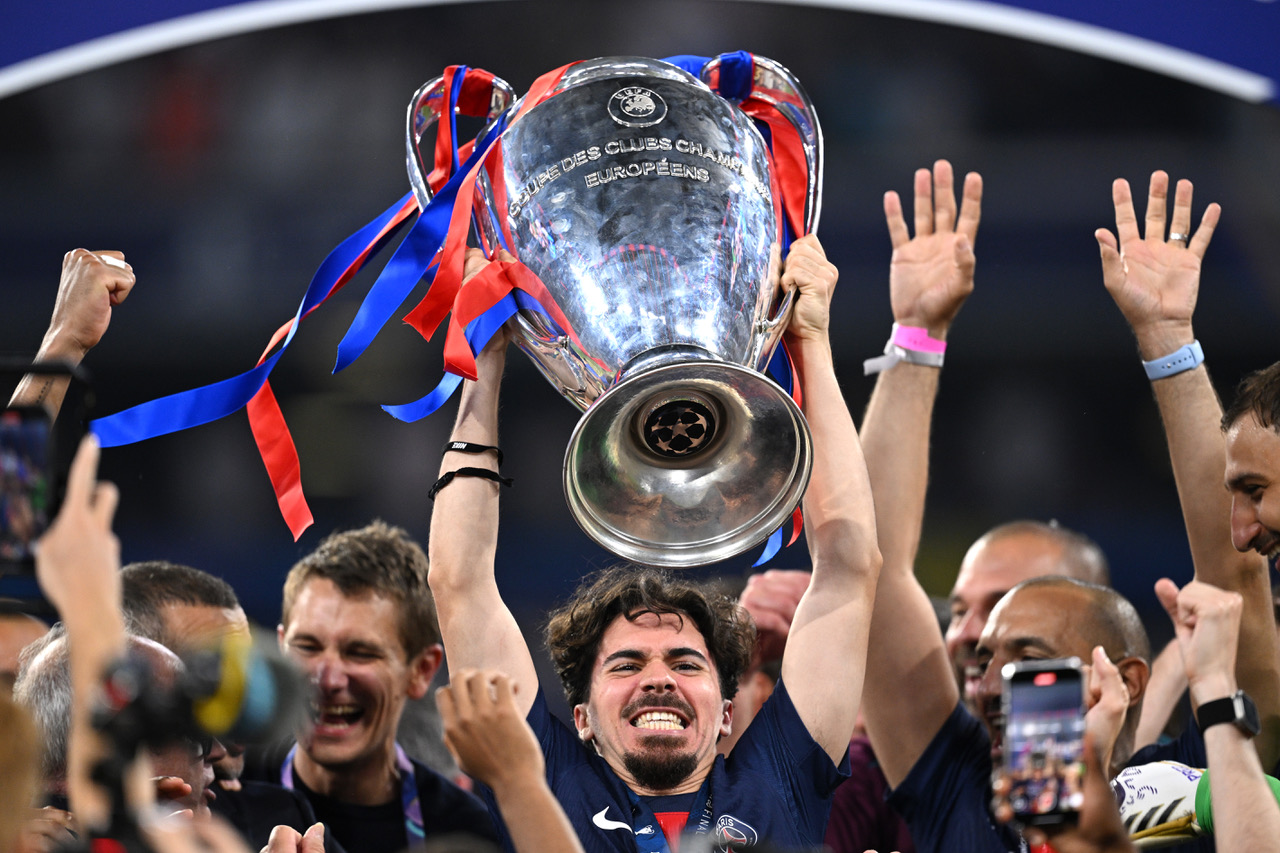 Vitinha of Paris Saint-Germain lifts the UEFA Champions League trophy