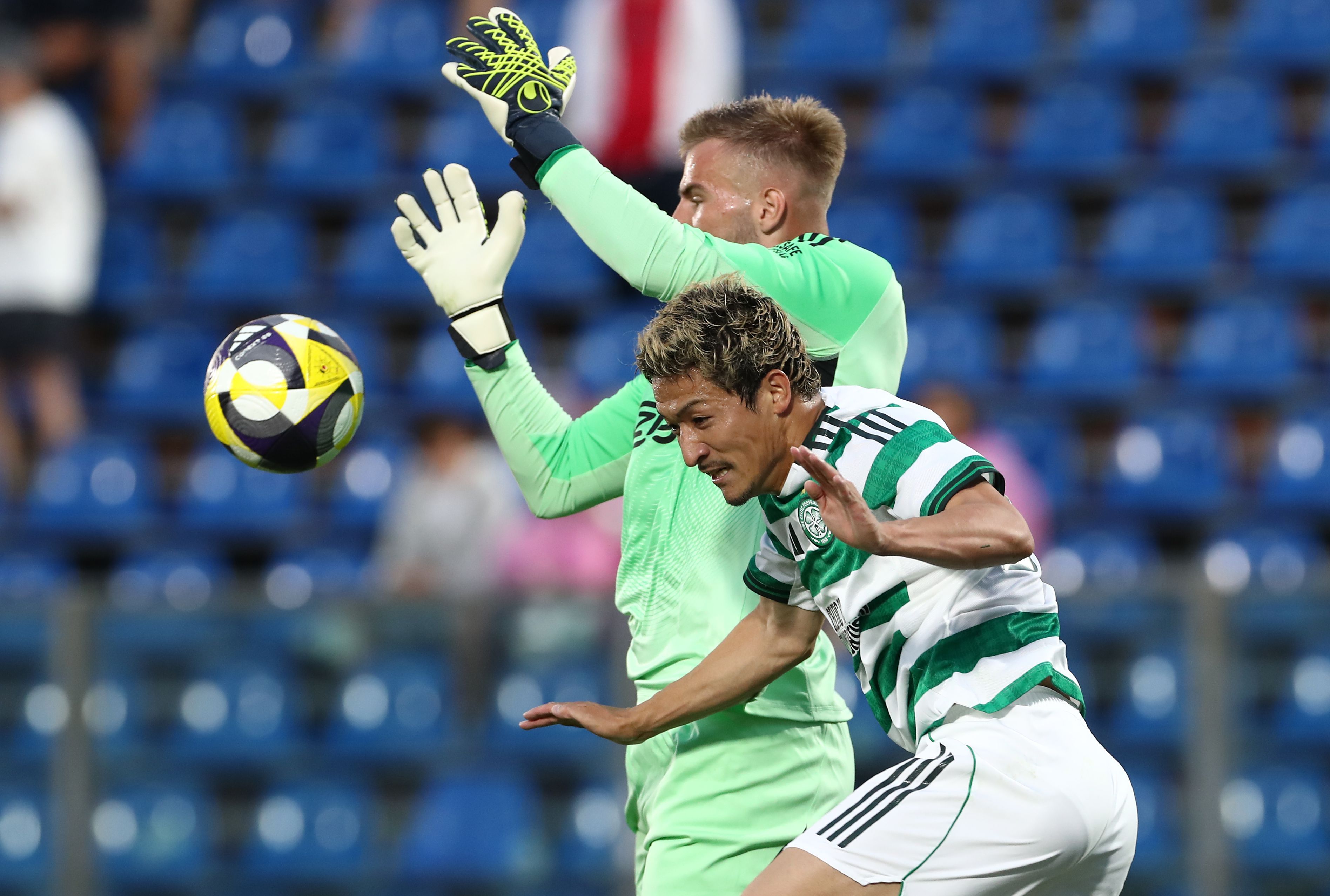 Daizen Maeta of Celtic FC and Vitezslav Jaros of Ajax jump for the ball 