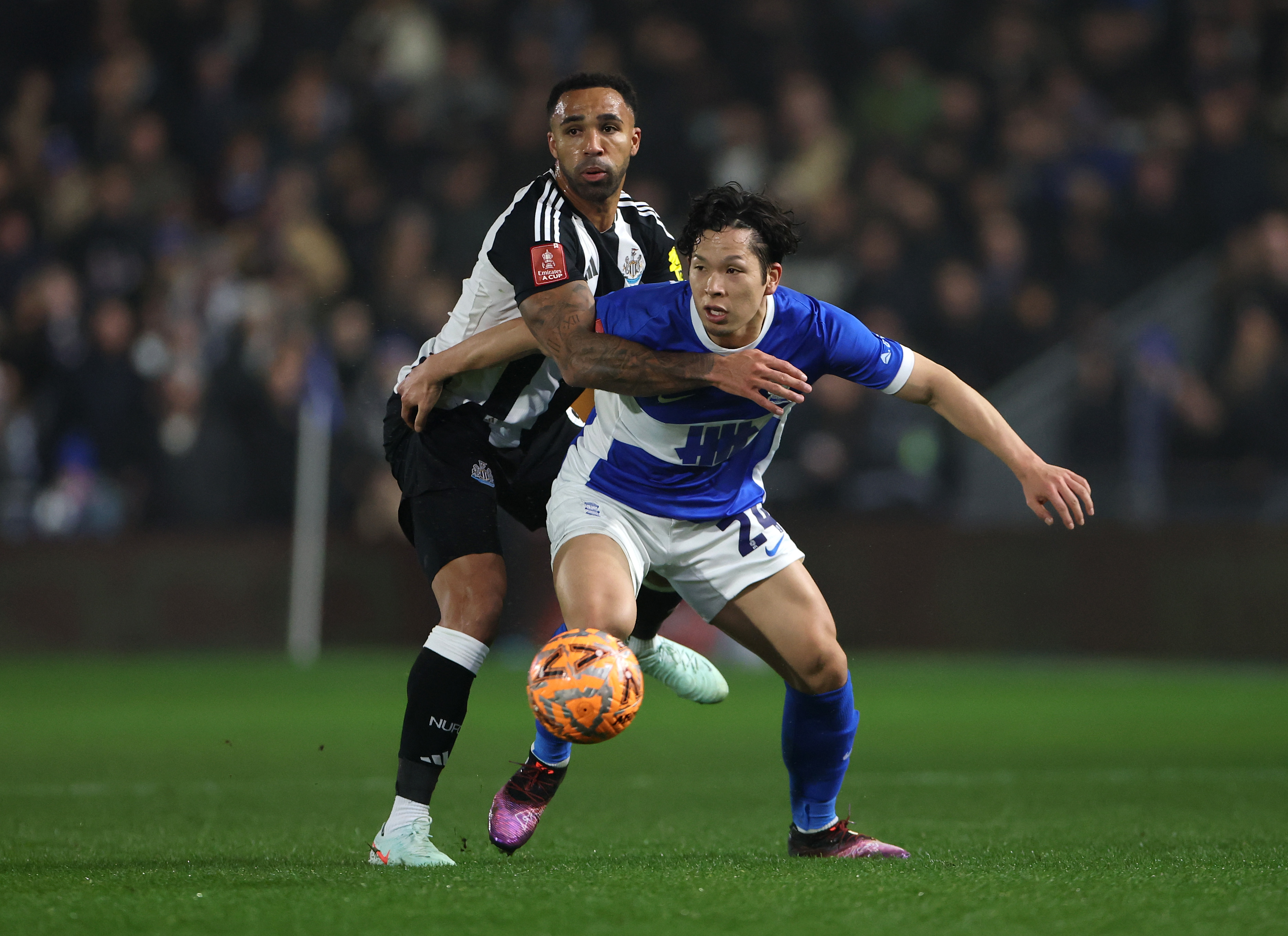 Tomoki Iwata of Birmingham City is challenged by Callum Wilson of Newcastle United