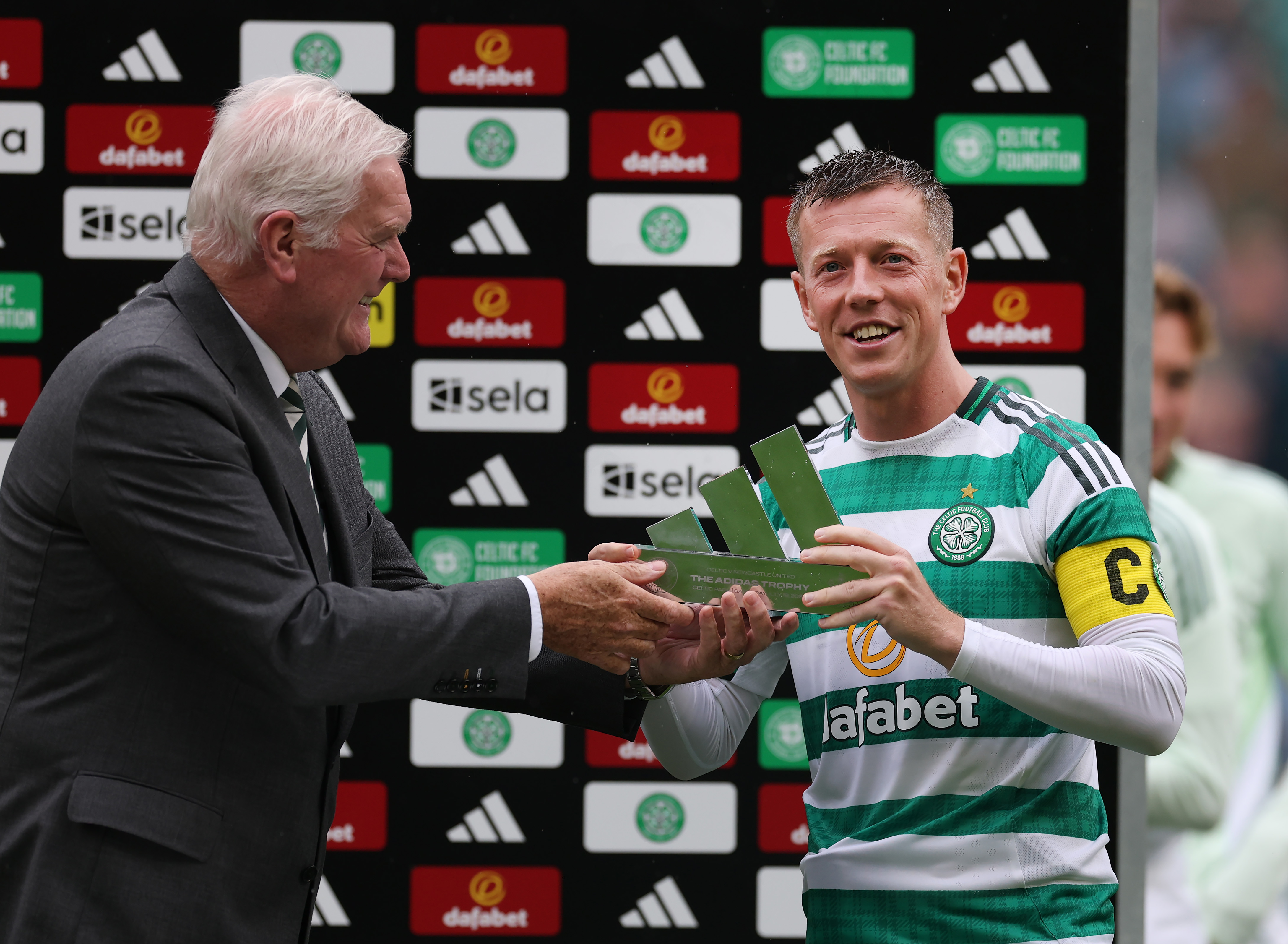 Callum McGregor of Celtic is presented with the Adidas Trophy by Roy Aitken