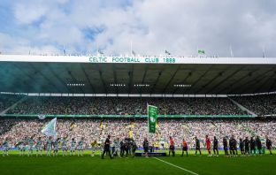 Former Celtic captain Paul McStay raises the flag