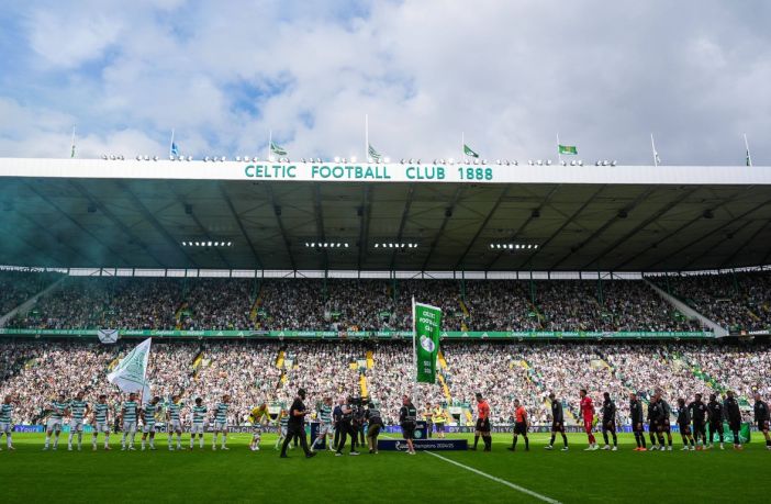 Former Celtic captain Paul McStay raises the flag