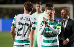Callum McGregor of Celtic applauds travelling fans