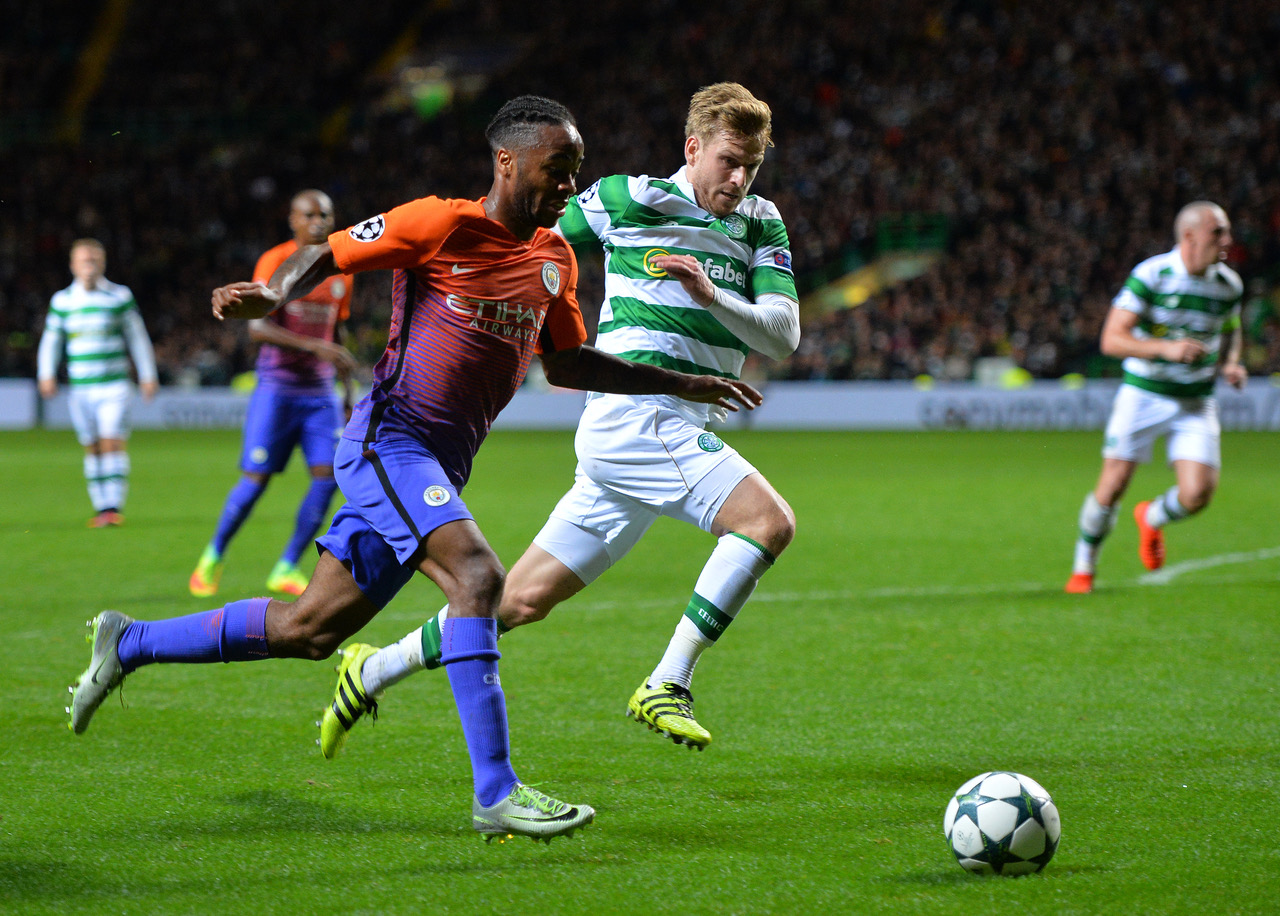 Raheem Sterling of Manchester City takes on Stuart Armstrong of Celtic