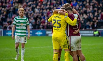 Hearts players celebrate as a dejected Liam Scales looks on