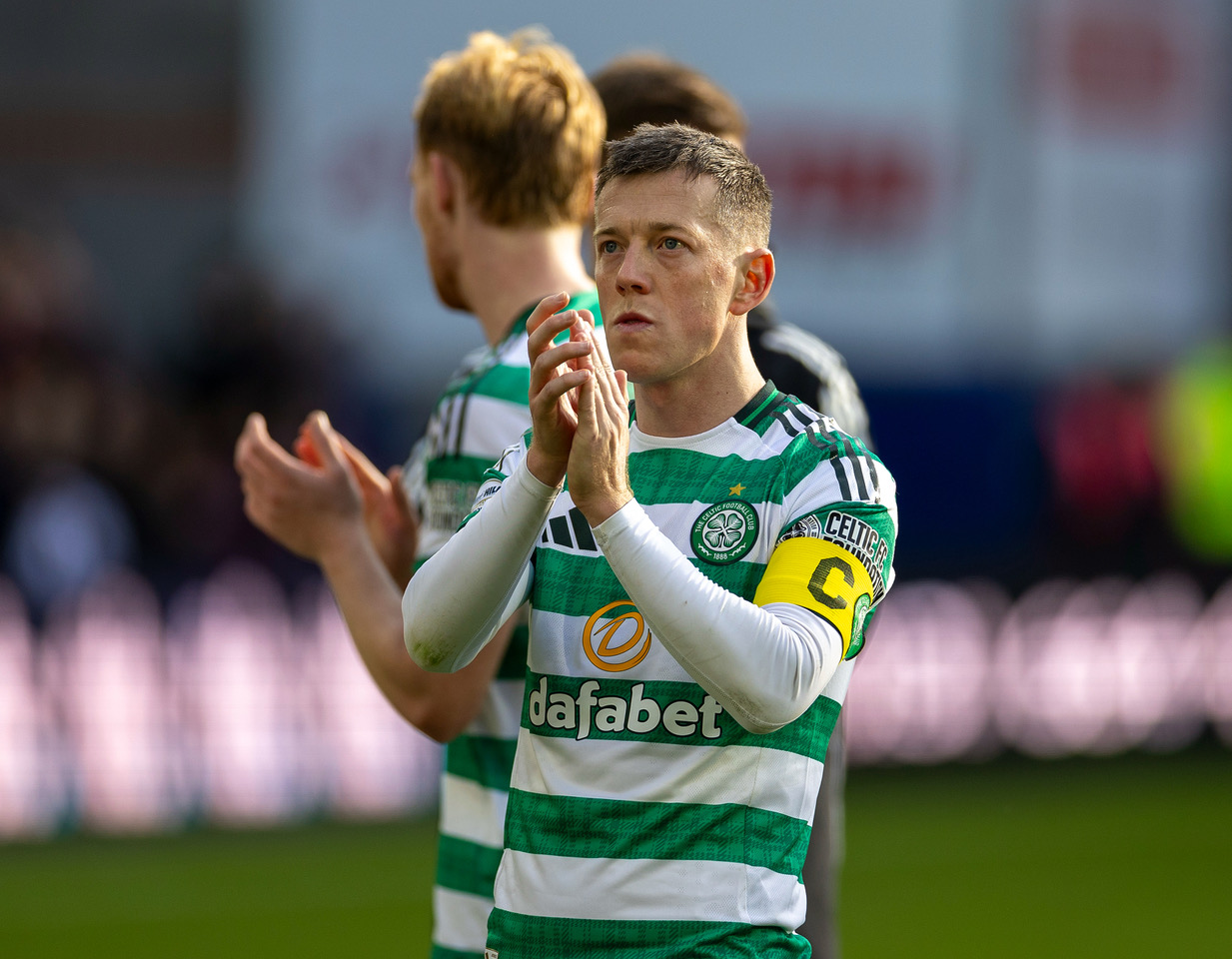 Callum McGregor applauds the Celtic supporters