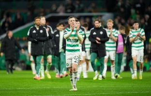 Callum McGregor applauds the fans