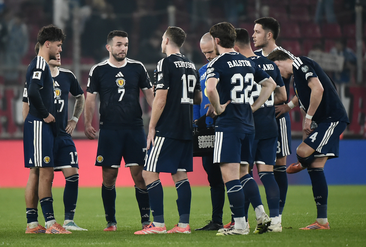 John McGinn of Scotland and teammates talking