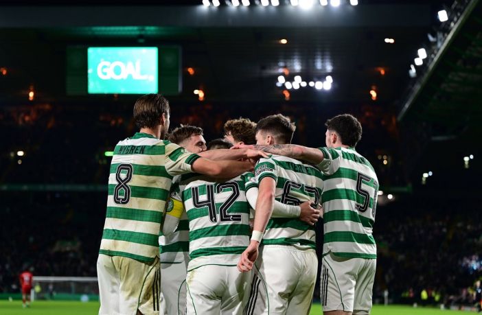 Celtic players celebrate the third goal by James Forrest.