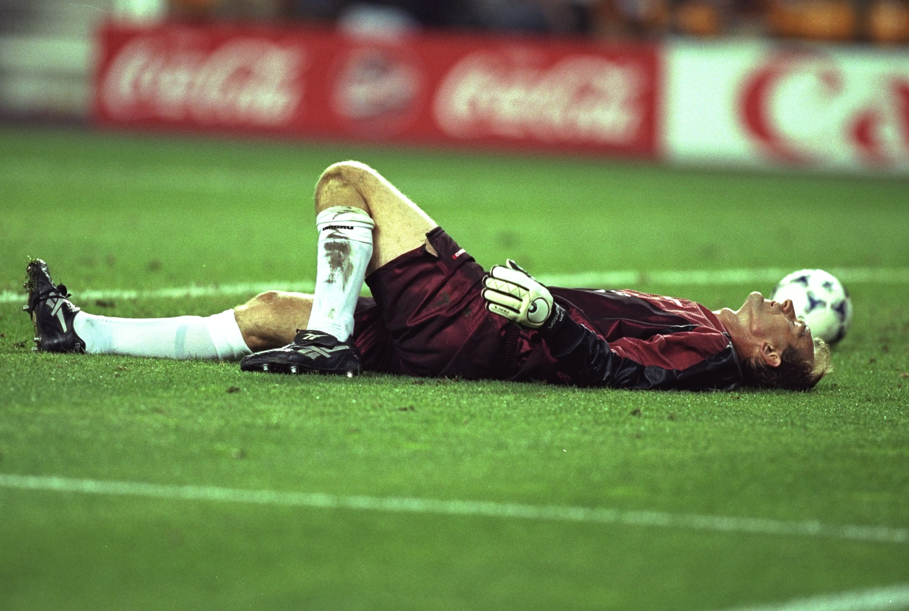 Jim Leighton of Scotland lies distraught 