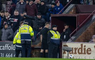 Referee Steven McLean viewing the footage on VAR screen.