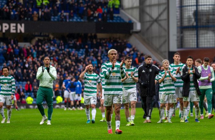 Celtic players applaud the Celtic support.