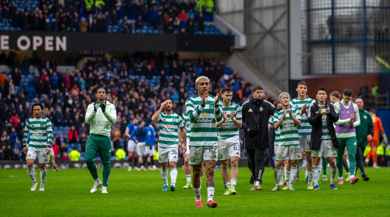 Celtic players applaud the Celtic support.
