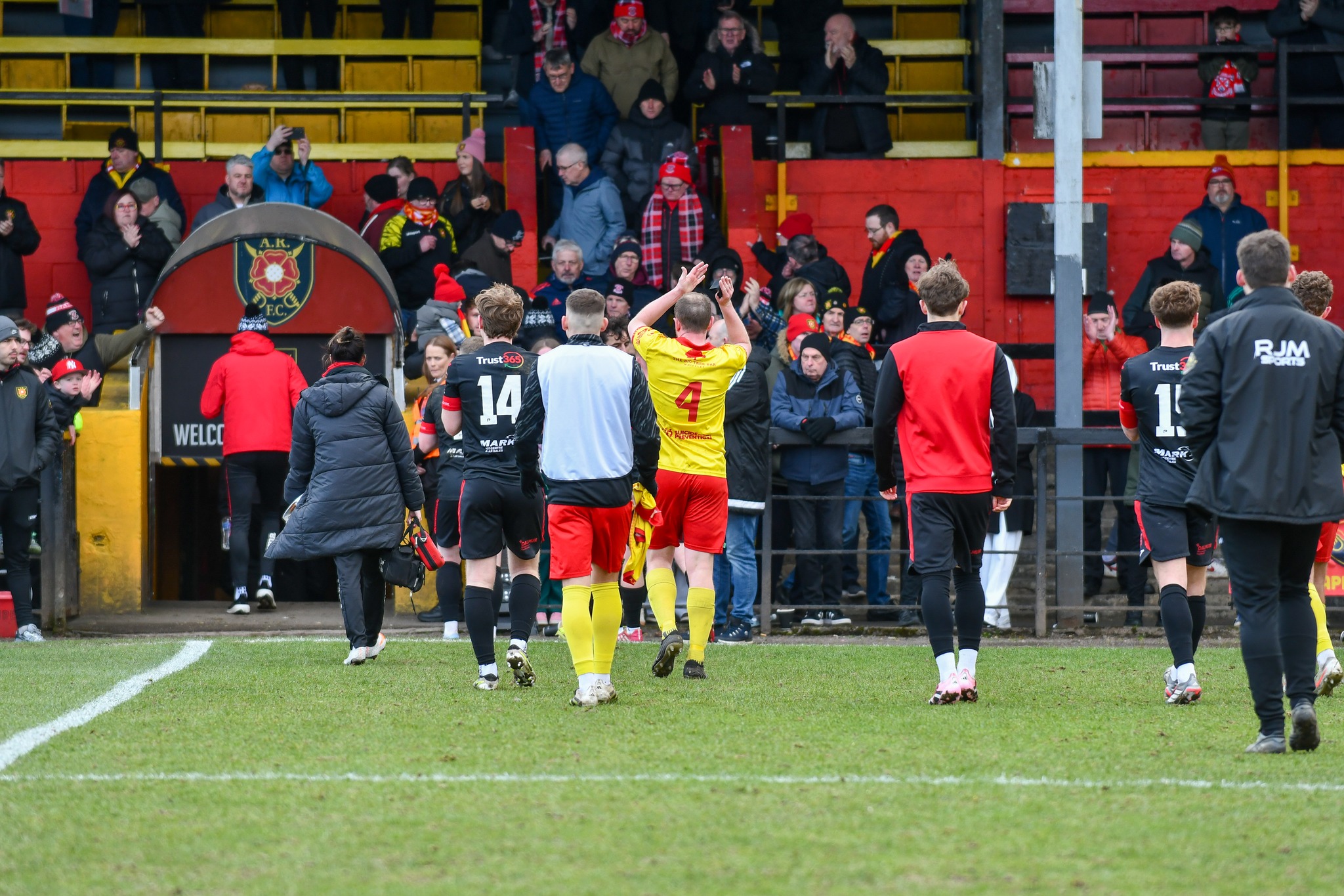 Albion Rovers players applaud the support.
