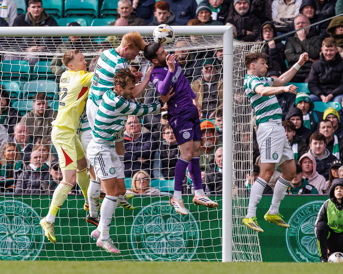 Liam Scales of Celtic challenges for a header