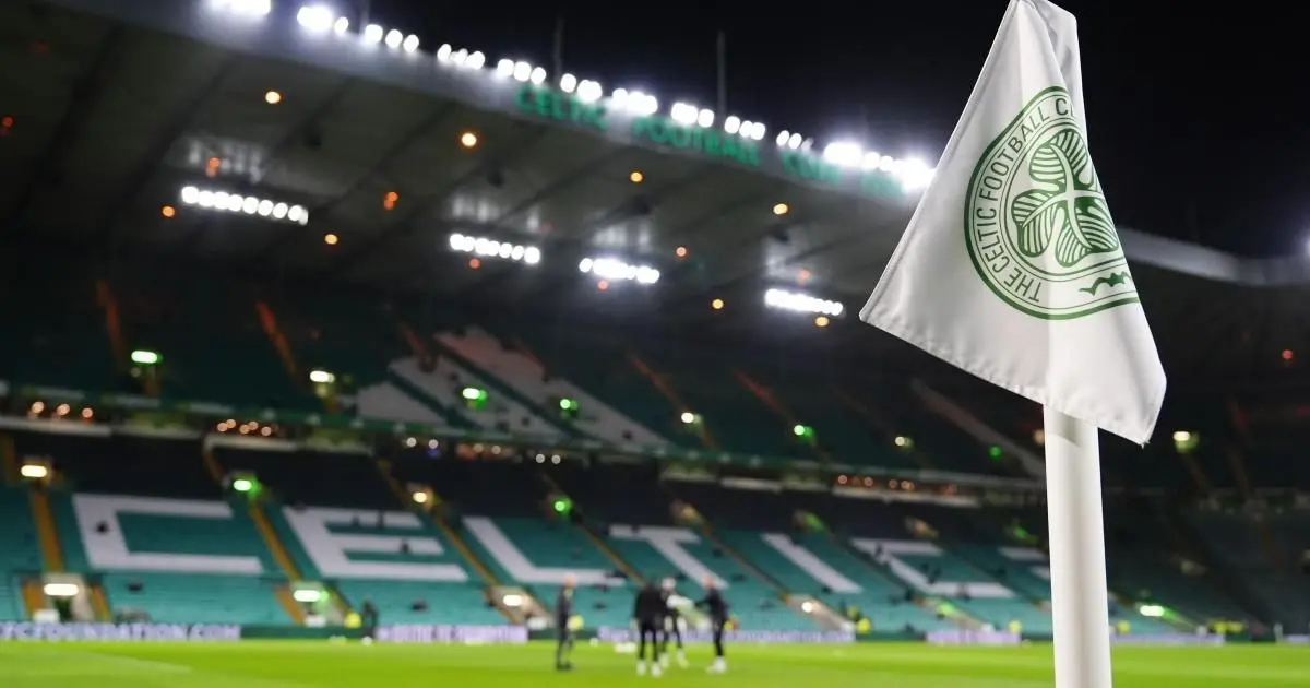 Celtic FC stadium with corner flag and empty stands at night.
