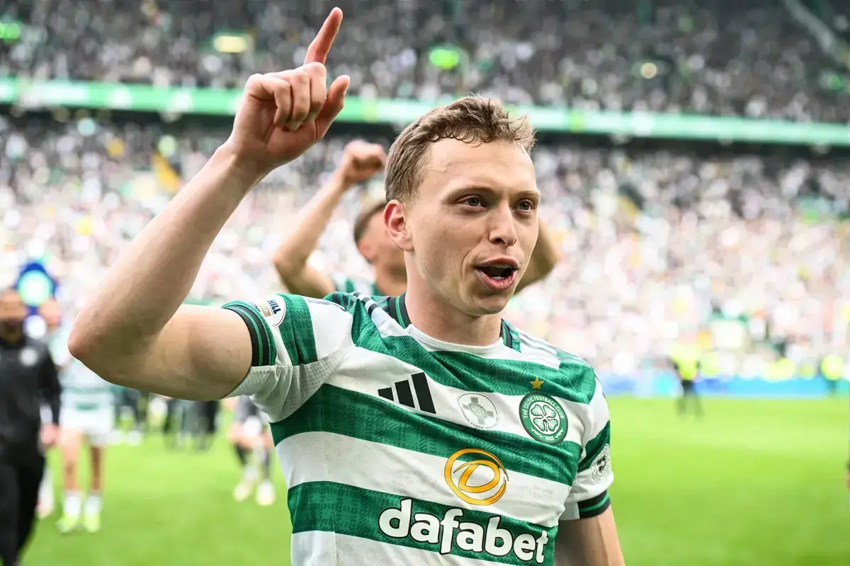 Alistair Johnston celebrating in a Celtic jersey during a match.