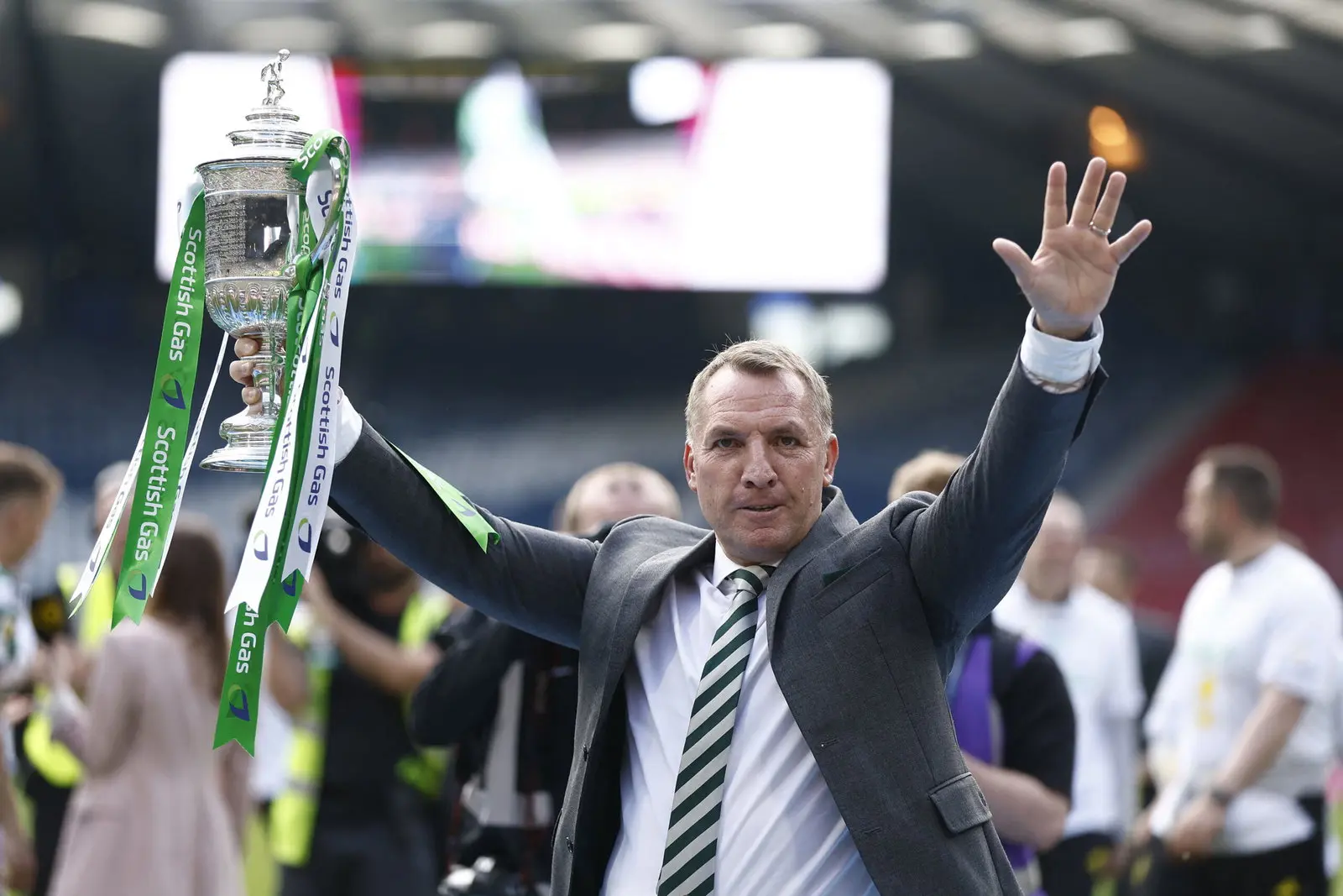 Brendan Rodgers holding the Scottish Cup triumphantly with celebration.