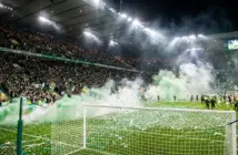 Celtic fans celebrate championship title win with green smoke and confetti at Paradise stadium