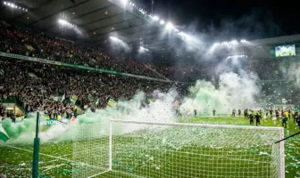 Celtic fans celebrate championship title win with green smoke and confetti at Paradise stadium