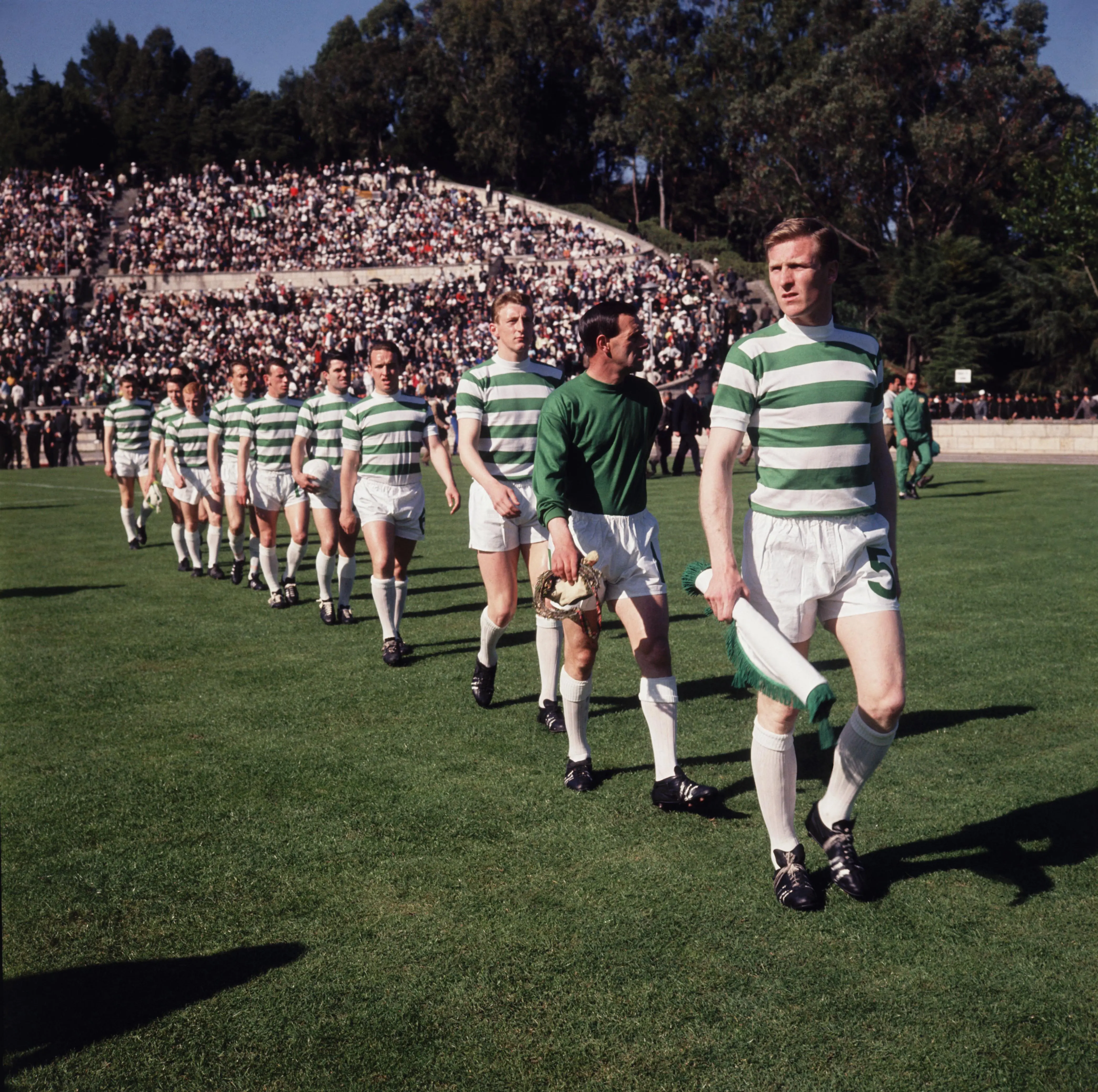 Celtic FC players in green and white stripes walking on the field during the 1967 Lisbon match.