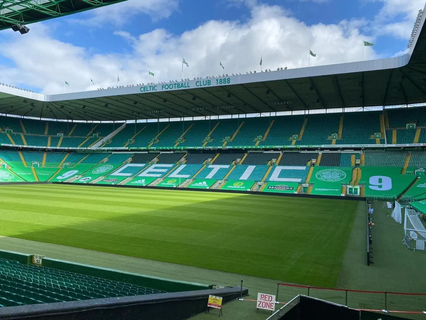 Interior view of Celtic Park stadium showing seating and pitch.