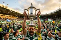 Scottish Cup trophy held high in celebration at Hampden Park with green and white confetti falling