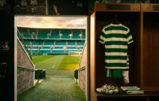 Celtic FC locker room with hoops jersey and view of Parkhead pitch symbolizing player transfers