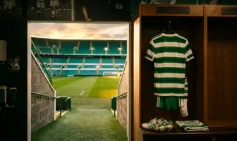 Celtic FC locker room with hoops jersey and view of Parkhead pitch symbolizing player transfers