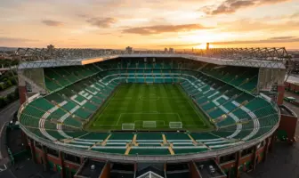 Celtic Park stadium bathed in golden light, showing empty stands and pitch from elevated view